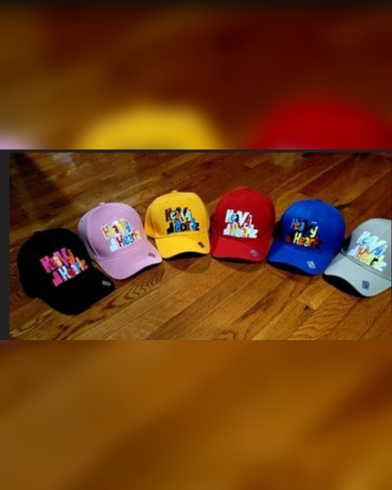 Heavy HeartZ branded hats in black, pink, yellow, red, blue, and gray