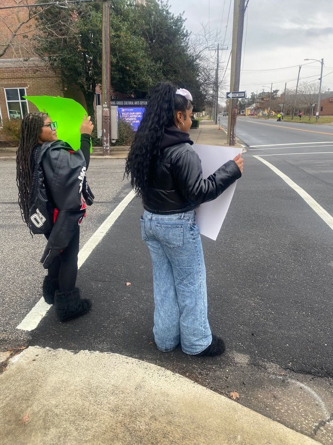 Volunteers holding signs at a street outreach event